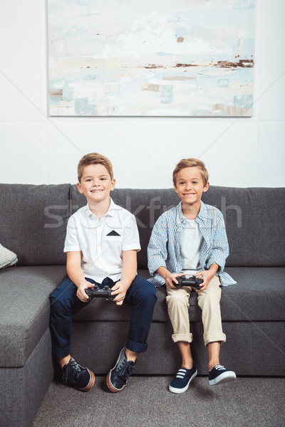 boys playing with joysticks Stock photo © LightFieldStudios