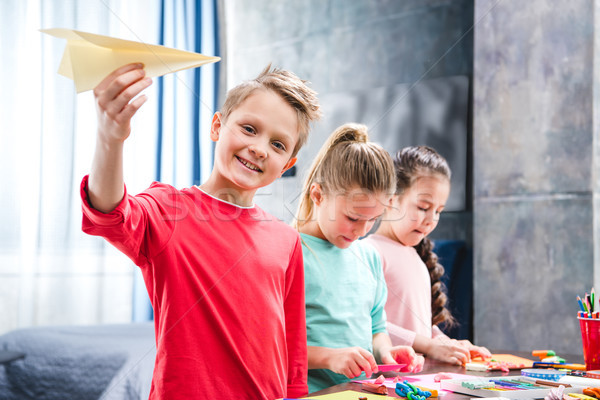 Kid playing with paper plane Stock photo © LightFieldStudios