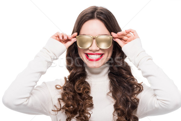 Cheerful woman in gold sunglasses Stock photo © LightFieldStudios