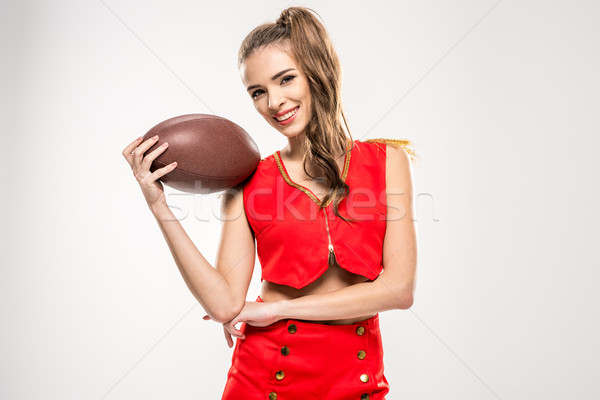 Homme cheerleader ballon de rugby souriant posant regarder [[stock_photo]] © LightFieldStudios