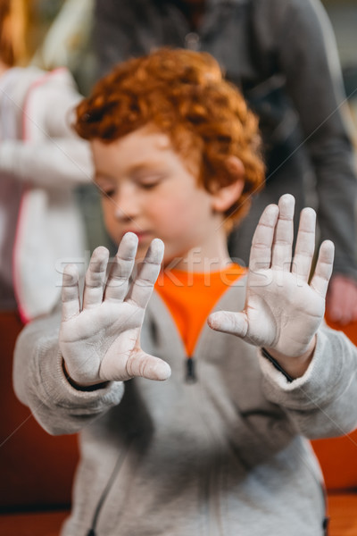 boy showing hands covered in talcum Stock photo © LightFieldStudios
