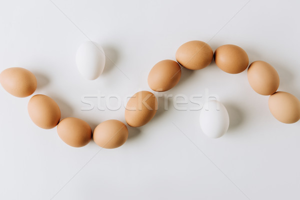 white and brown eggs laying on white background Stock photo © LightFieldStudios