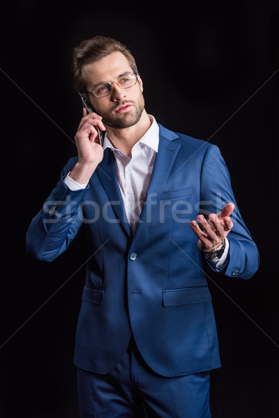 Businessman talking on smartphone Stock photo © LightFieldStudios
