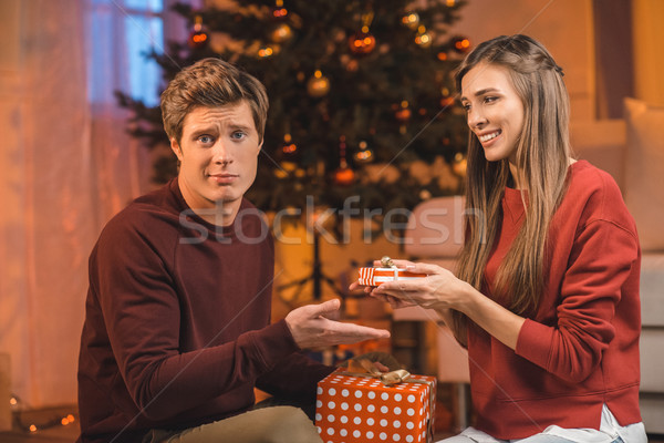 couple exchanging christmas gifts Stock photo © LightFieldStudios