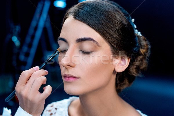 makeup artist applying eye shadows Stock photo © LightFieldStudios