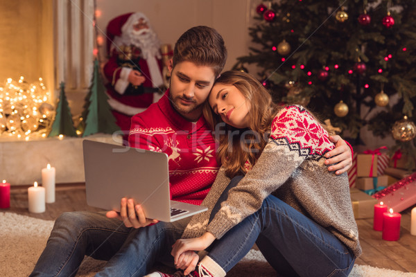 couple with laptop at christmastime Stock photo © LightFieldStudios