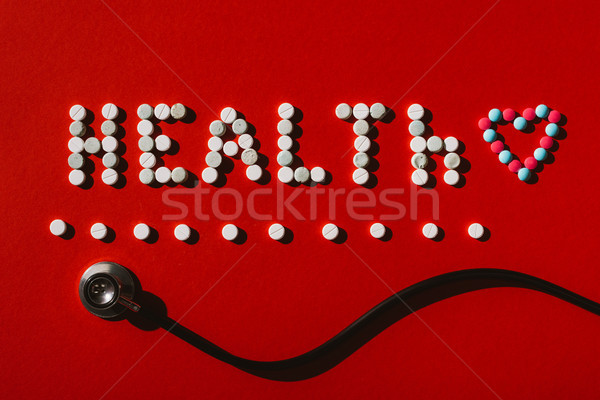 Woord gezondheid pillen stethoscoop top Stockfoto © LightFieldStudios