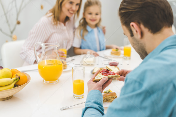 selective focus of man having breakfast together with family at home Stock photo © LightFieldStudios