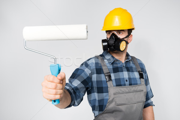 Construction worker with paint roller Stock photo © LightFieldStudios