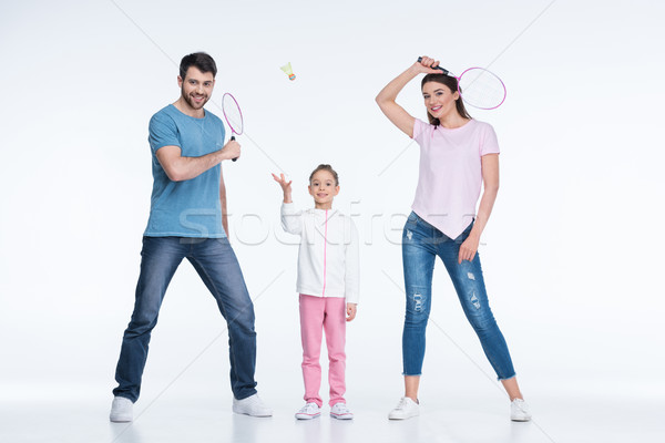 smiling family with badminton rackets and shuttlecock on white   Stock photo © LightFieldStudios