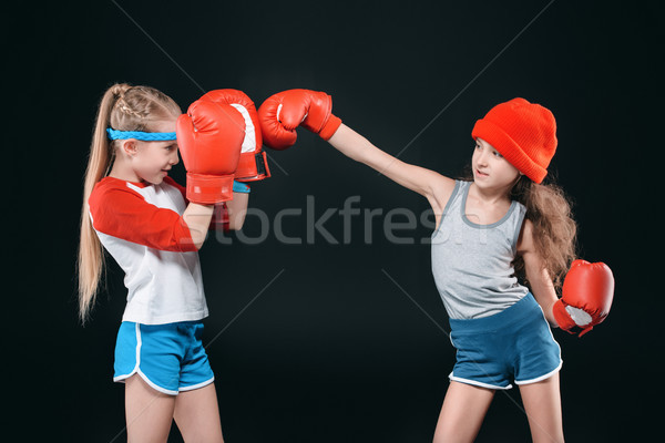 side view of sportive girls pretending boxing isolated on black, active kids concept Stock photo © LightFieldStudios
