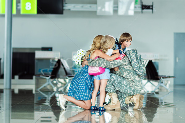 family hugging father at airport Stock photo © LightFieldStudios