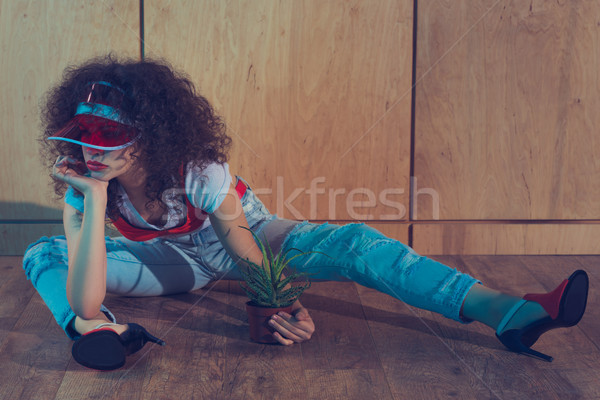 fashionable woman with plant in flowerpot Stock photo © LightFieldStudios