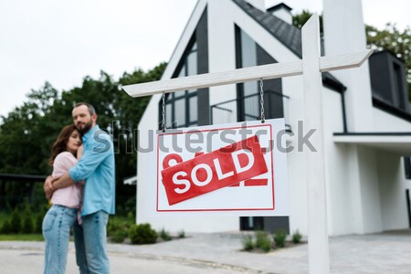 Człowiek wiszący sprzedany podpisania domu budynku Zdjęcia stock © LightFieldStudios