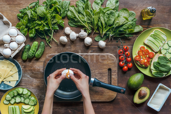Stock photo: woman cooking egg