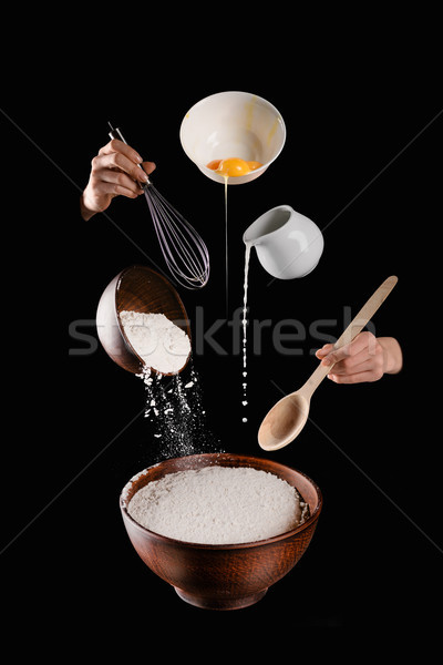 cropped image of woman making pastry isolated on black Stock photo © LightFieldStudios