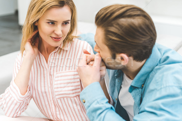 portrait of tender man kissing wifes hand at home stock ph picture