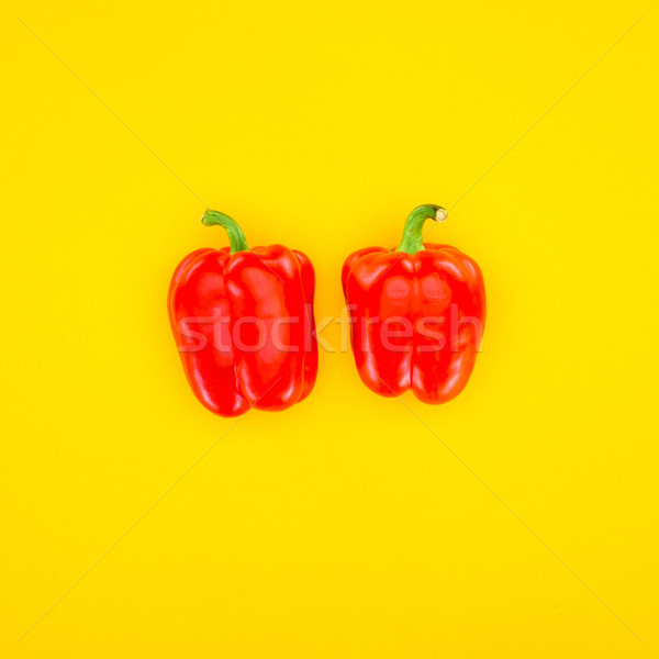top view of fresh red paprika peppers isolated on yellow Stock photo © LightFieldStudios