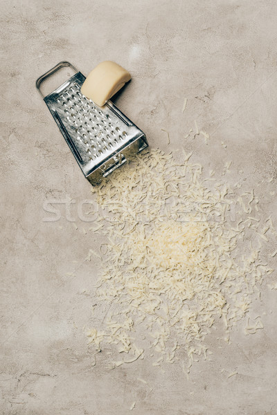 Grater and piece of cheese on light background Stock photo © LightFieldStudios