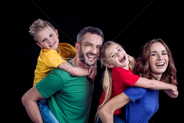 Happy family smiling at camera Stock photo © LightFieldStudios