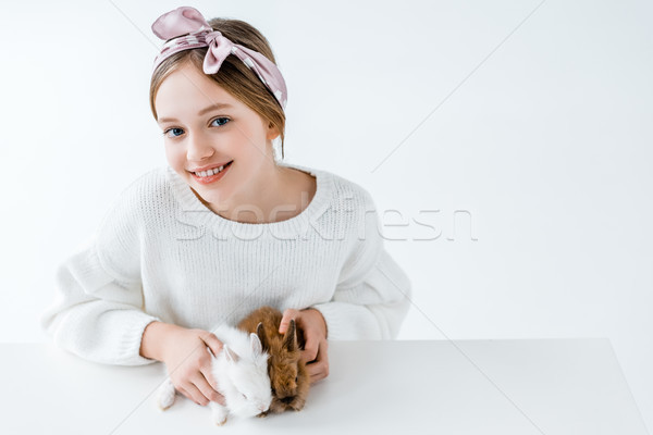 beautiful girl holding adorable furry rabbits and smiling at camera on white Stock photo © LightFieldStudios