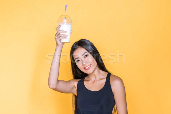 Asian woman holding milkshake Stock photo © LightFieldStudios
