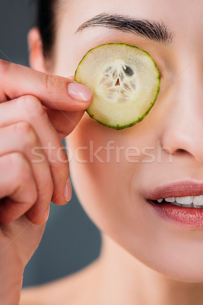 Vrouw plakje komkommer oog shot schoonheid Stockfoto © LightFieldStudios