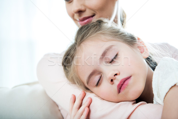 little girl sleeping on mother's arm at home Stock photo © LightFieldStudios