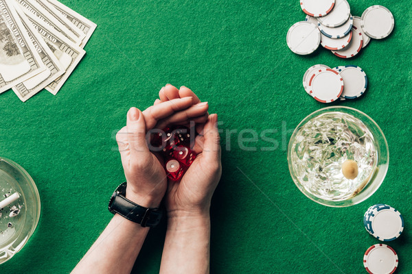 Woman playing dice game by casino table with money and chips Stock photo © LightFieldStudios