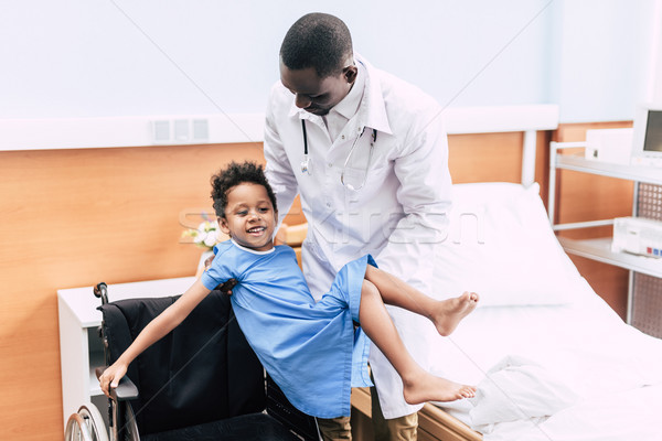 african american doctor and disabled patient Stock photo © LightFieldStudios