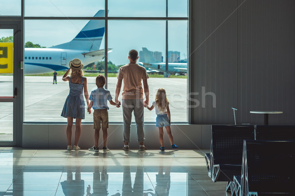 Stock photo: family looking out window in airport