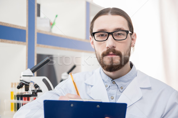 Homme scientifique lunettes jeunes note [[stock_photo]] © LightFieldStudios