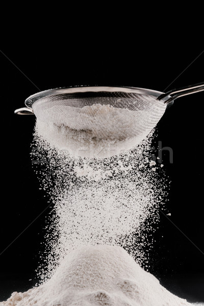 white flour falling from sieve on pile isolated on black Stock photo © LightFieldStudios