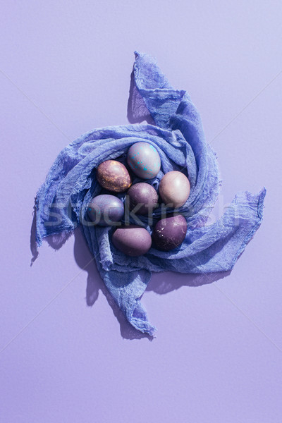 top view of traditional easter eggs on gauze, on purple Stock photo © LightFieldStudios