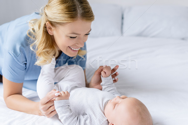 mother holding babys hands Stock photo © LightFieldStudios