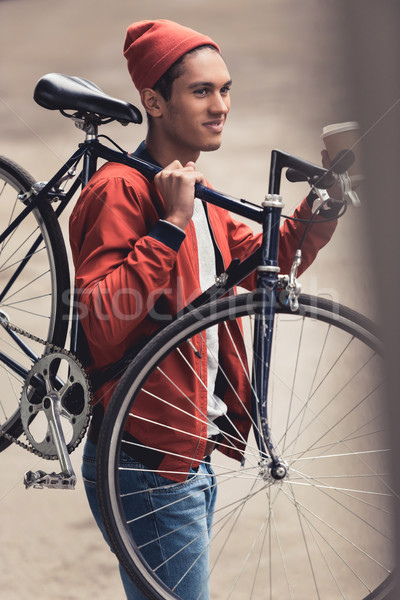 man with bicycle drinking coffee to go Stock photo © LightFieldStudios