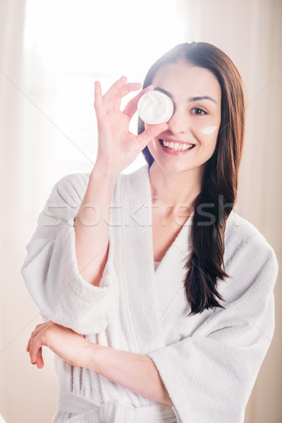 Stock photo: woman showing open jar of cream
