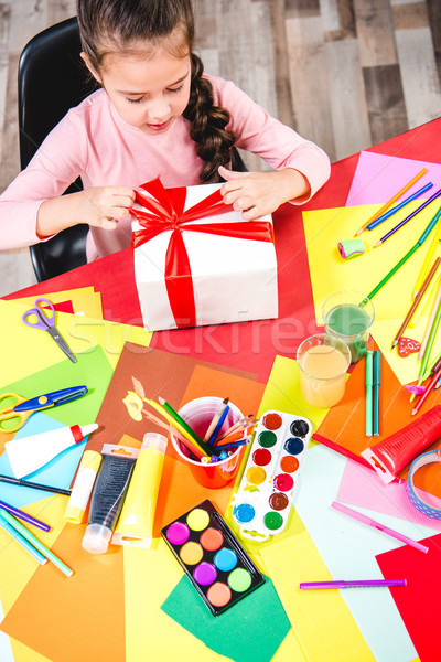 Schoolchild wrapping gift box  Stock photo © LightFieldStudios