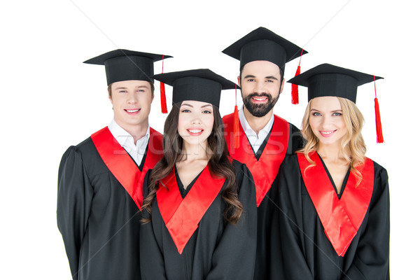 Group of young men and women in graduation caps looking at camera  Stock photo © LightFieldStudios