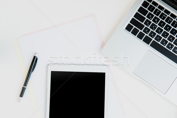 Top view of laptop and digital tablet with blank screen and office supplies on table top. laptop tab Stock photo © LightFieldStudios