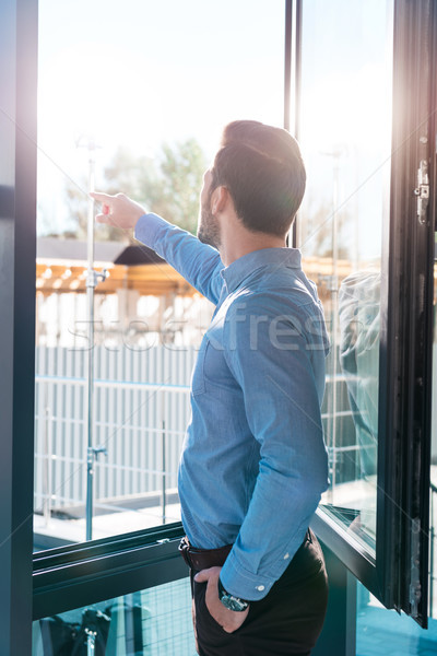businessman pointing at window Stock photo © LightFieldStudios