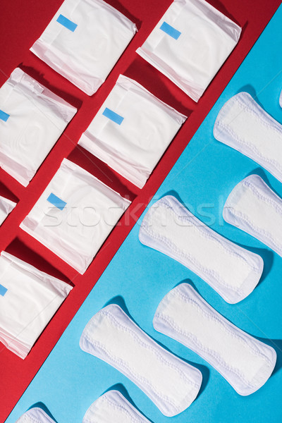 top view of rows of pads and daily liners on red and blue Stock photo © LightFieldStudios