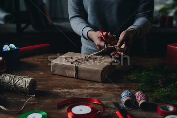 woman decorating christmas gift Stock photo © LightFieldStudios
