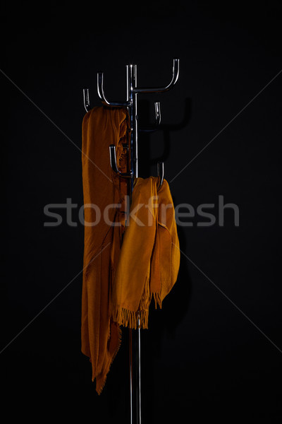 yellow scarves on coat rack isolated on black Stock photo © LightFieldStudios