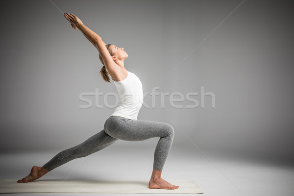 Woman standing in yoga position Stock photo © LightFieldStudios