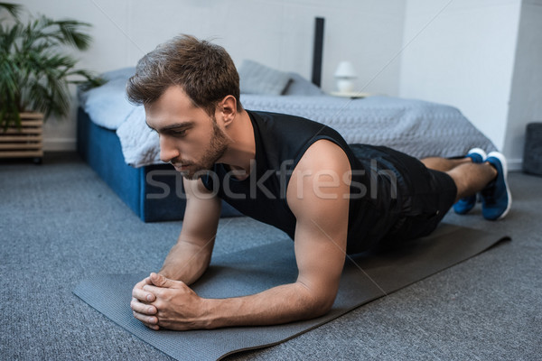 Adam yatak odası genç yakışıklı adam egzersiz Stok fotoğraf © LightFieldStudios