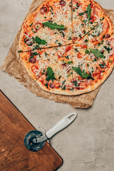  Italian pizza and pizza cutter on light background Stock photo © LightFieldStudios