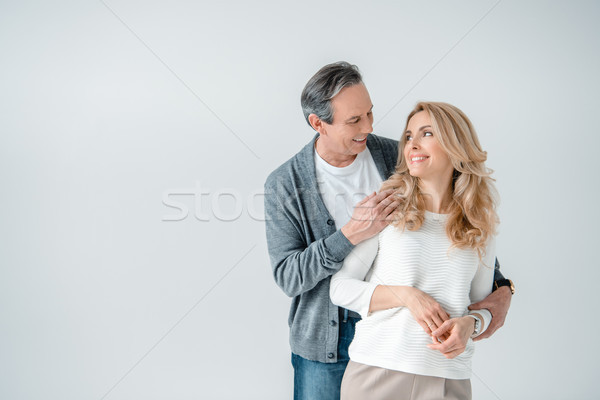 portrait of smiling stylish mature man and woman on grey Stock photo © LightFieldStudios