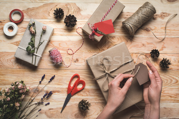 woman decorating christmas gift Stock photo © LightFieldStudios