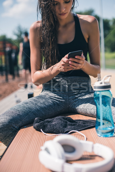 sportive woman using smartphone Stock photo © LightFieldStudios